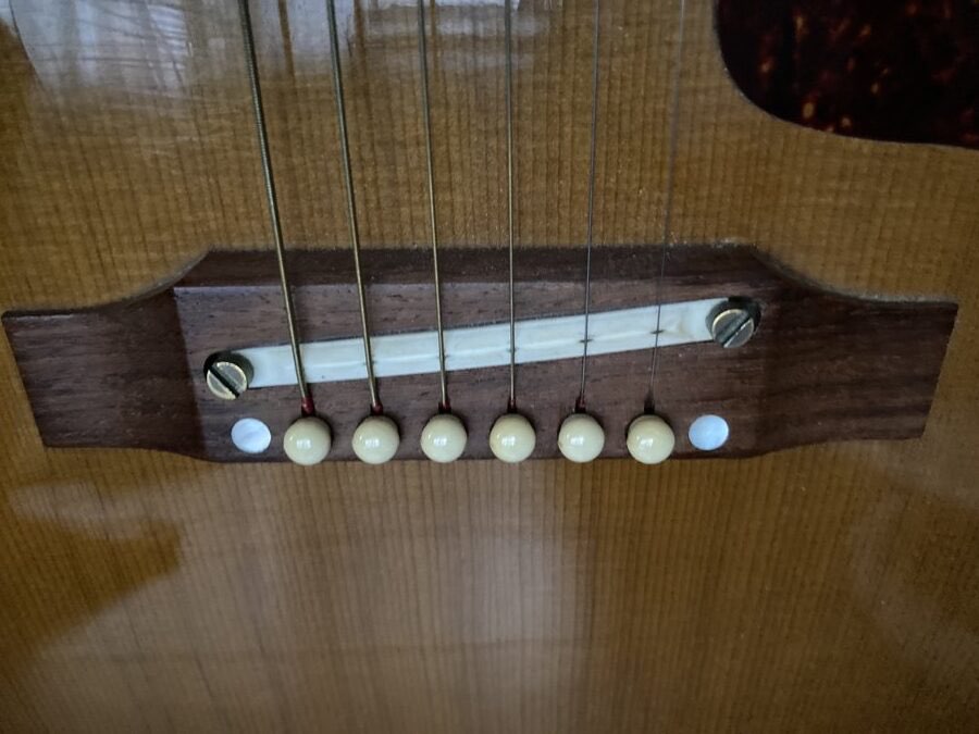 The bridge of the Gibson J-160E with the replaced saddle